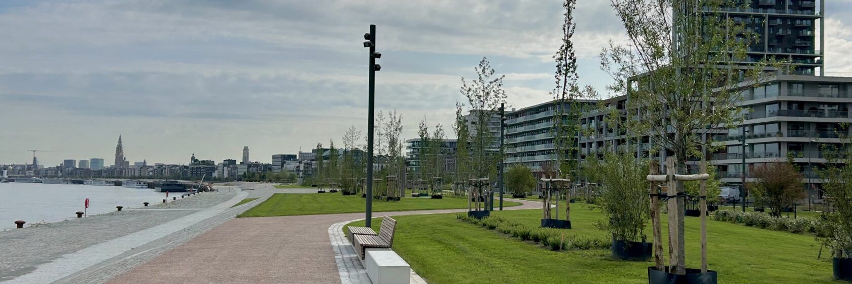 photo of the Nieuw Zuid Scheldekaaien park, with view of the river Scheldt and Antwerp cathedral in the distance