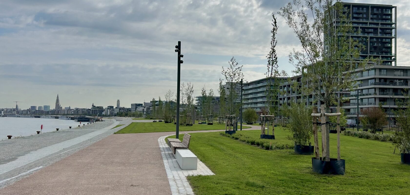 photo of the Nieuw Zuid Scheldekaaien park, with view of the river Scheldt and Antwerp cathedral in the distance