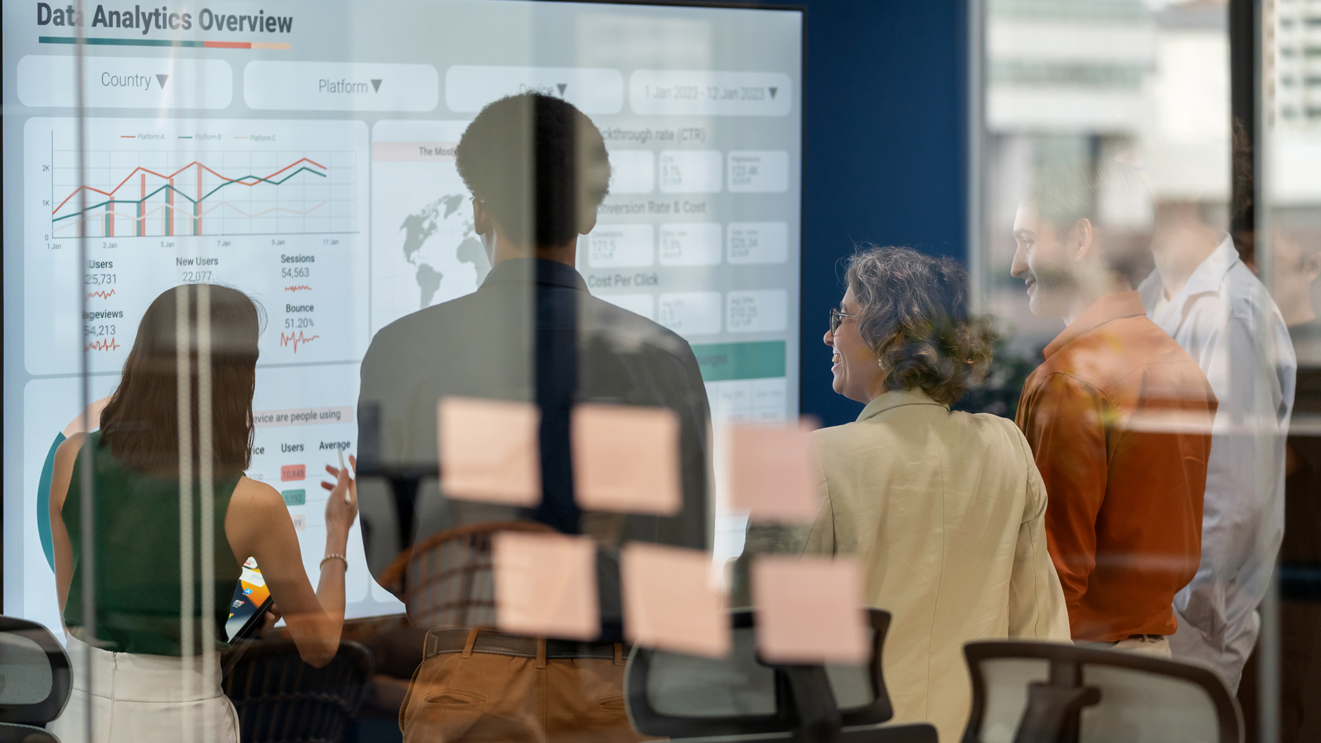 team standing in front of screen and discussing