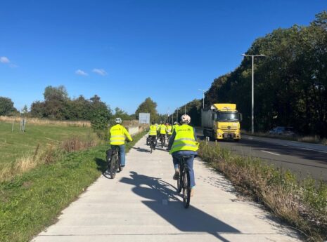 photo of a cyclist with Sweco safety jacket on a bicycle on a separate bike lane