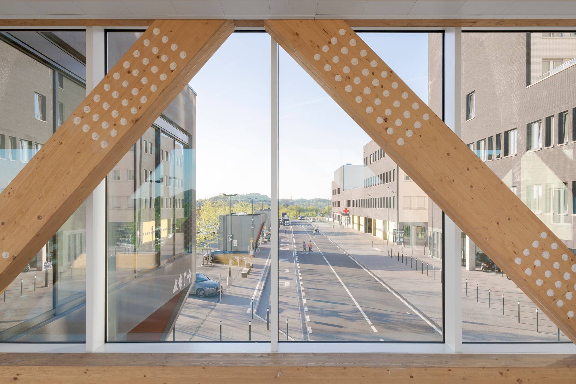 exterior photo of Grand Hopital de Charleroi, taken from the footbridge on the inside showing timber laminated trusses