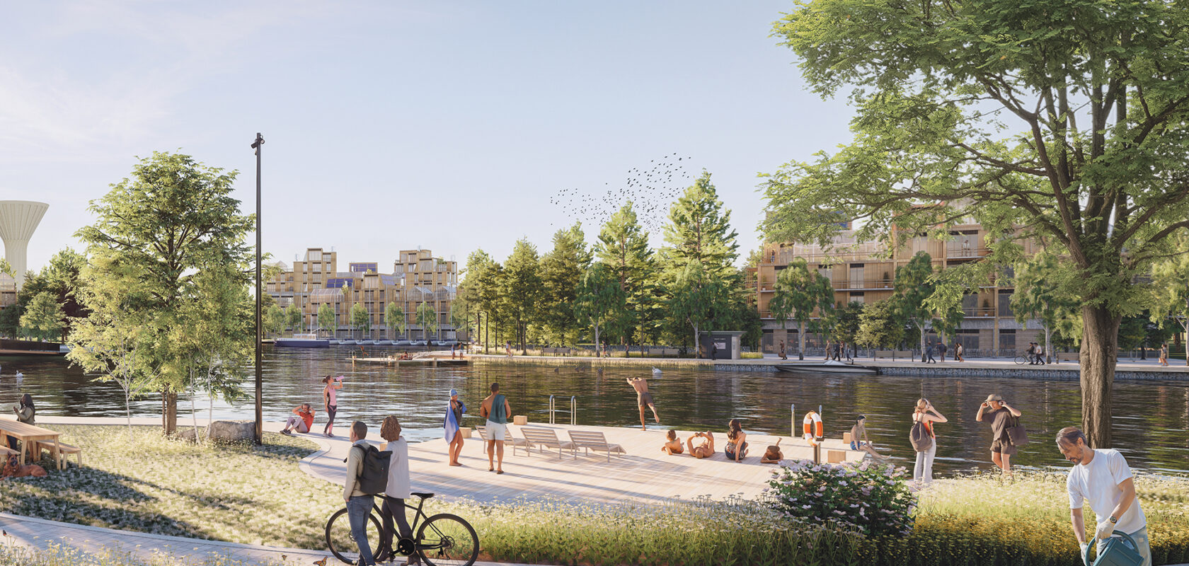 stadsbeeld aan het water met groen en mensen